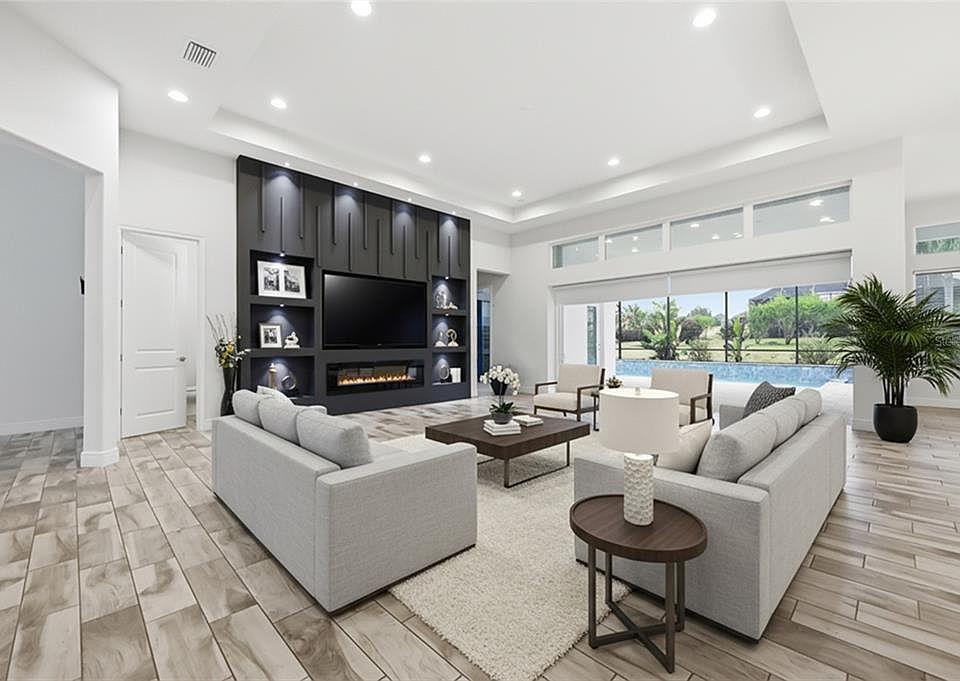 Custom fireplace wall installation in Melbourne FL with black built in media wall shelves and linear fireplace near me