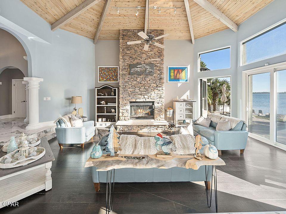 High ceiling stone fireplace wall installation in Melbourne FL with custom fireplace and waterfront luxury home near me