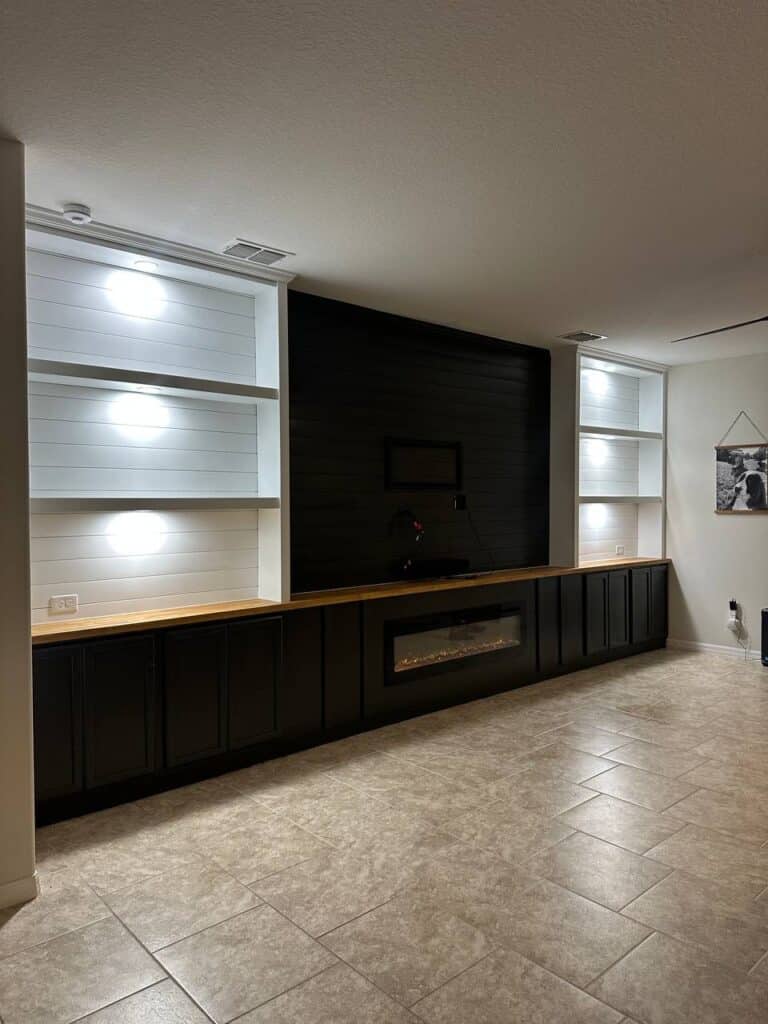 Custom built in media wall with fireplace shelving and cabinets in Florida home