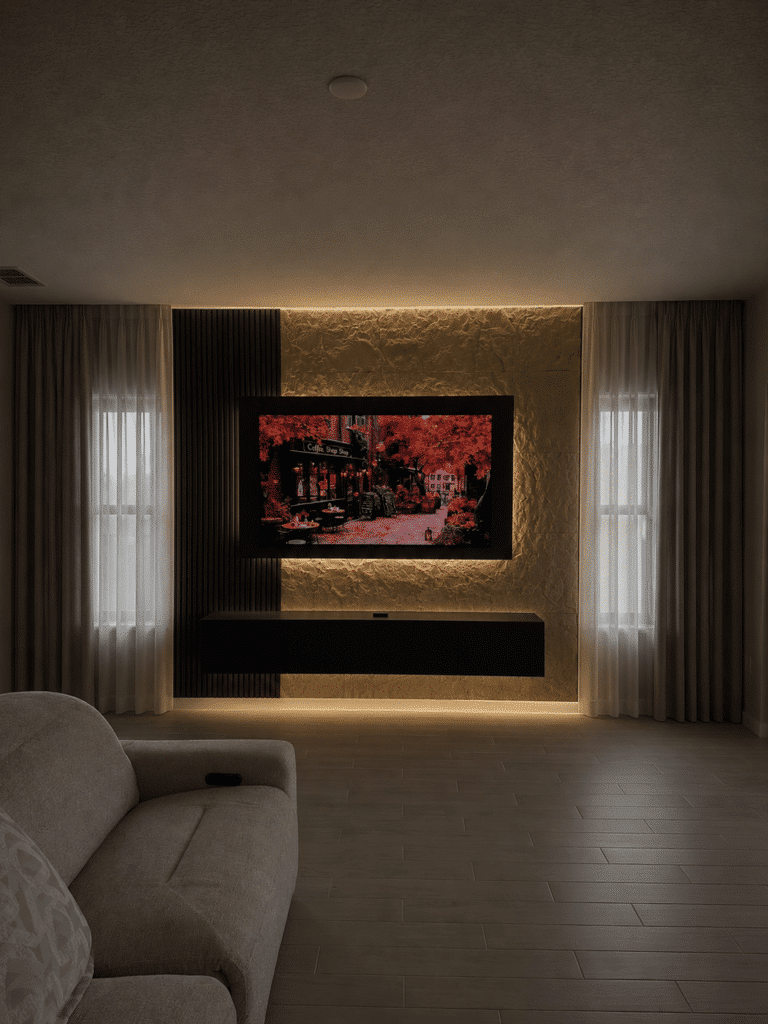 Luxury custom TV wall with floating media cabinet and ambient LED lighting completed in Orlando Florida