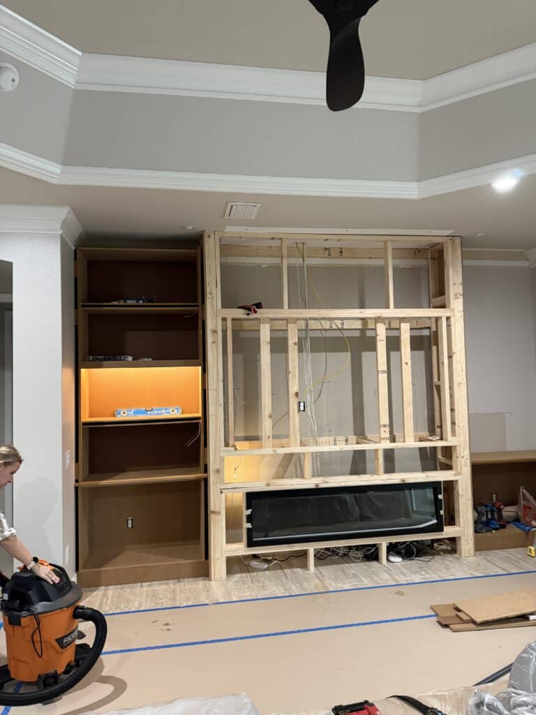 Custom built-in TV wall installation process with cabinetry and lighting preparation