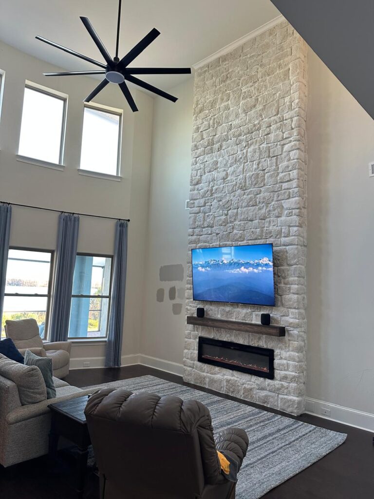 fireplace wall FAQ Florida with stone fireplace media wall and mounted TV
