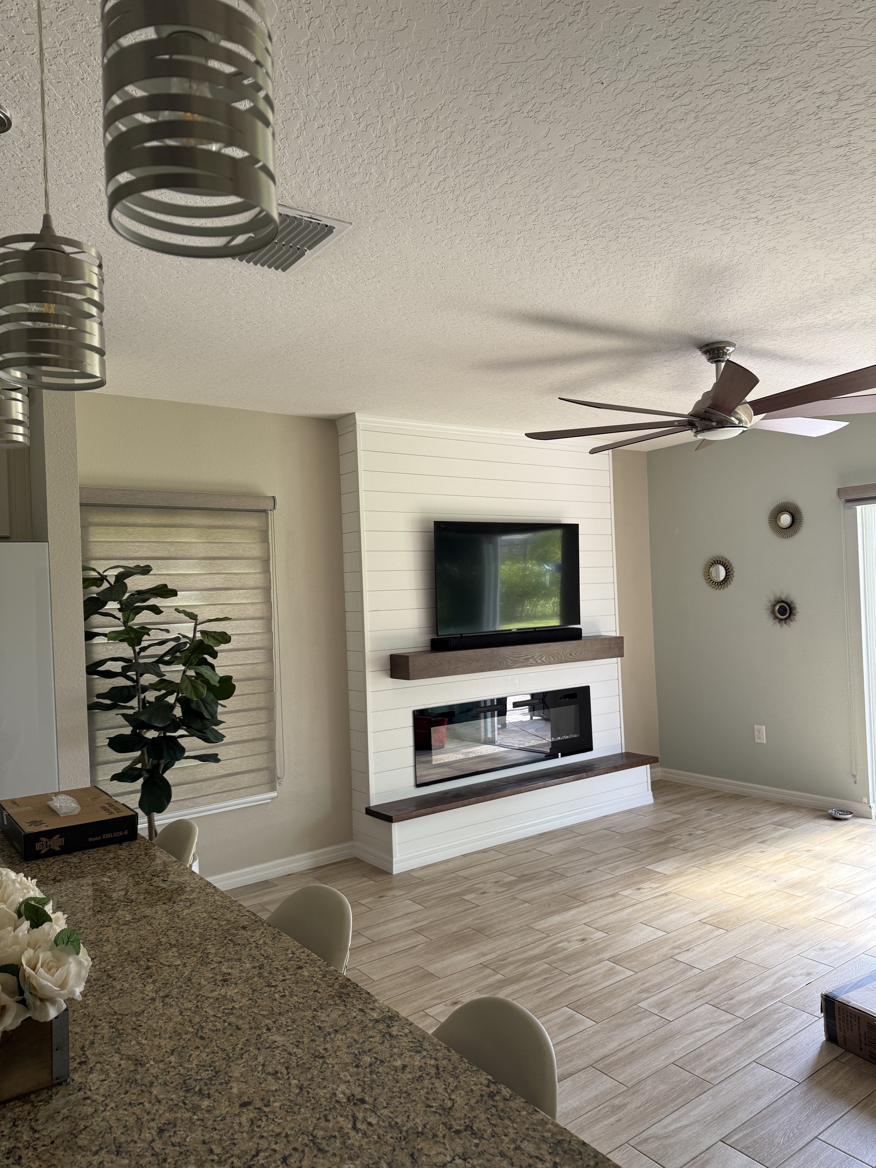 Modern black fireplace wall with built-in shelving — fireplace wall services florida